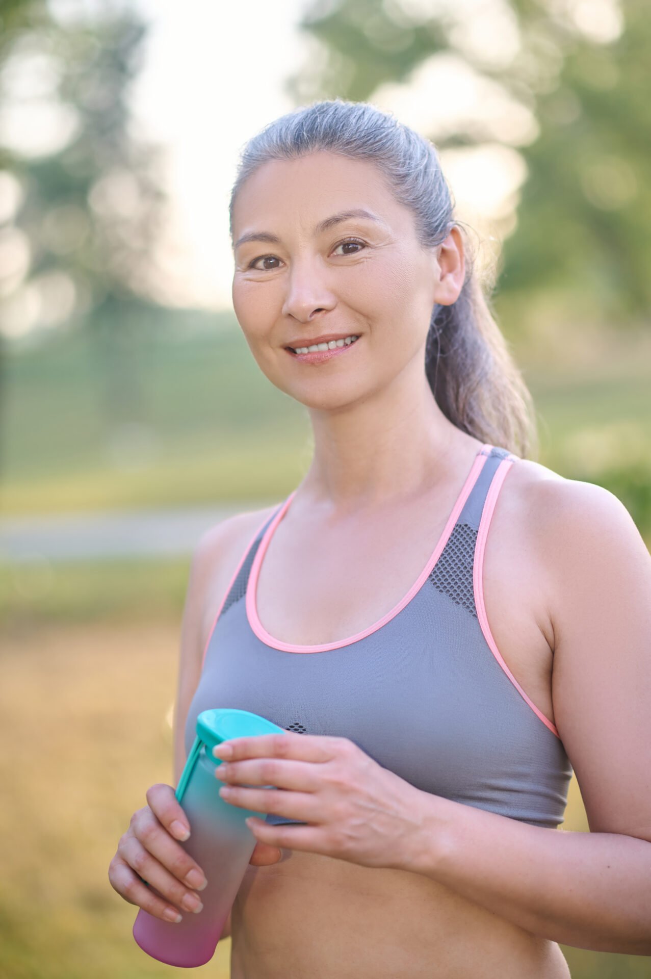 A pretty mature woman in sportswear smiling nicely