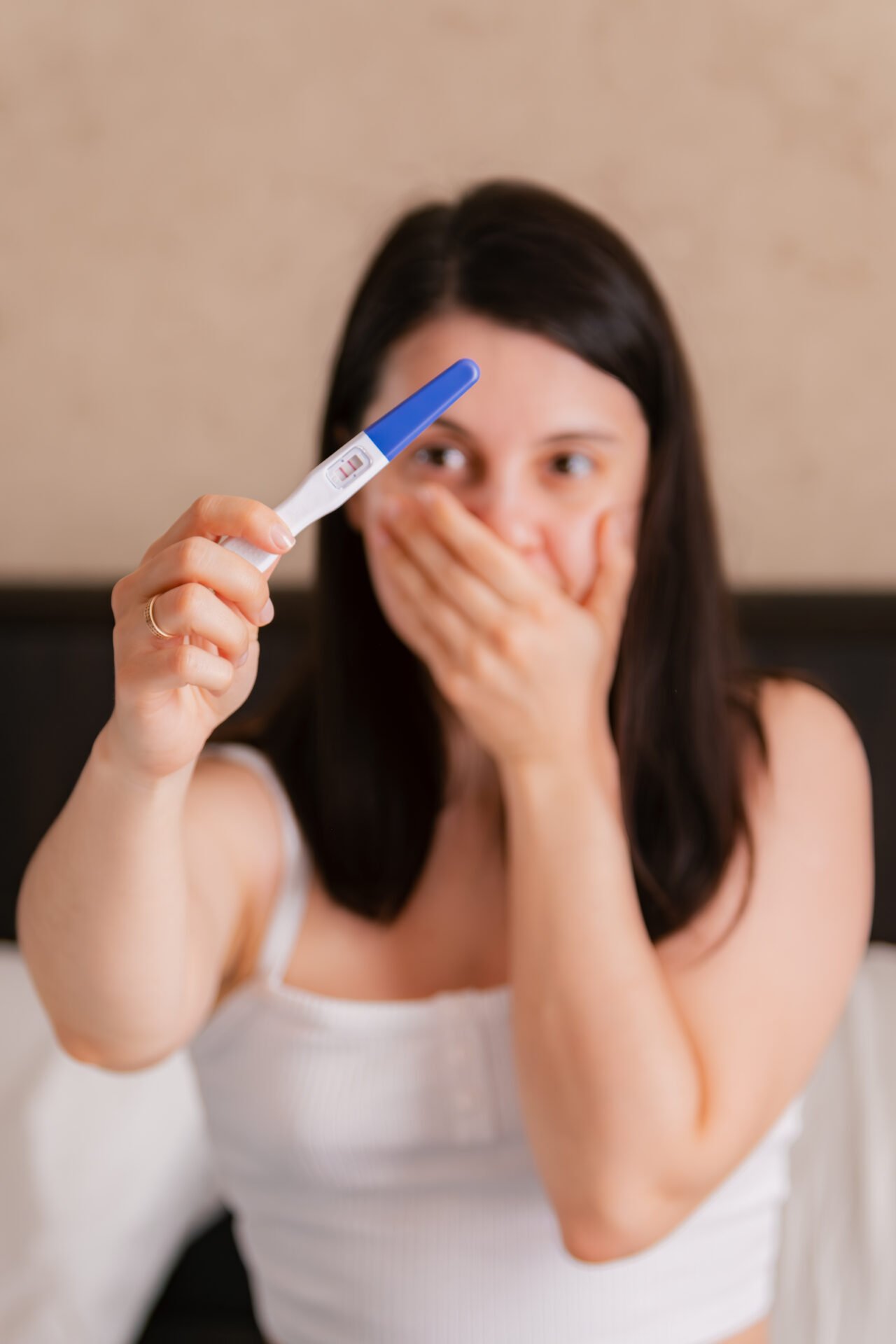 happy woman showing positive pregnancy test